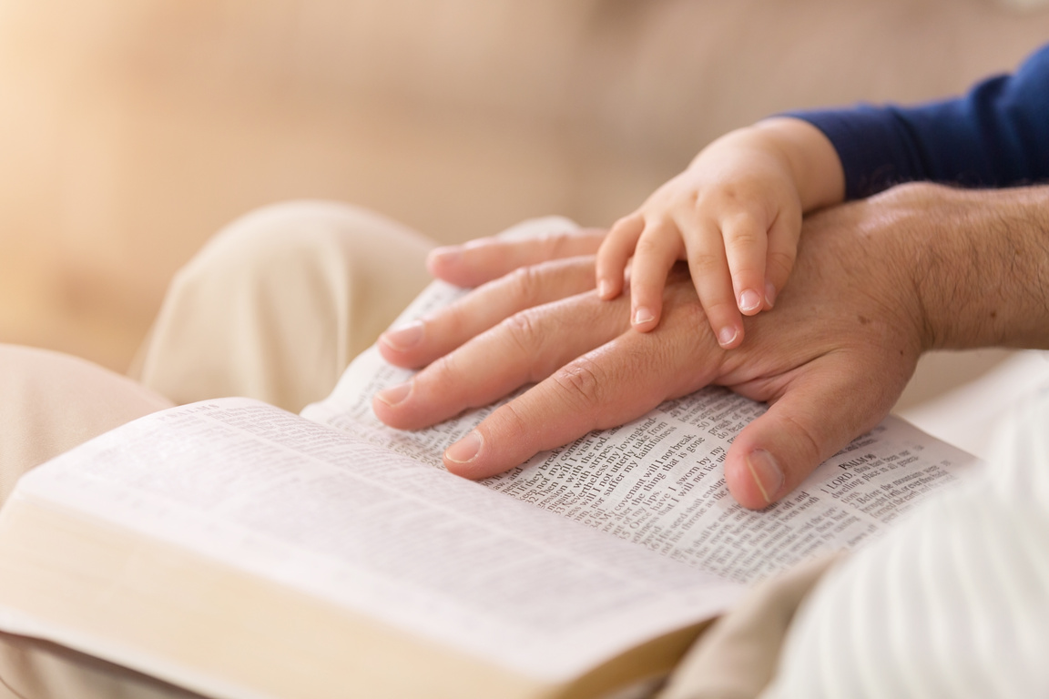 Grandpa Reading to Baby Boy from the Bible