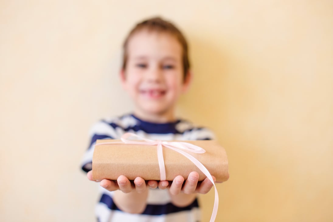 child holds out a gift