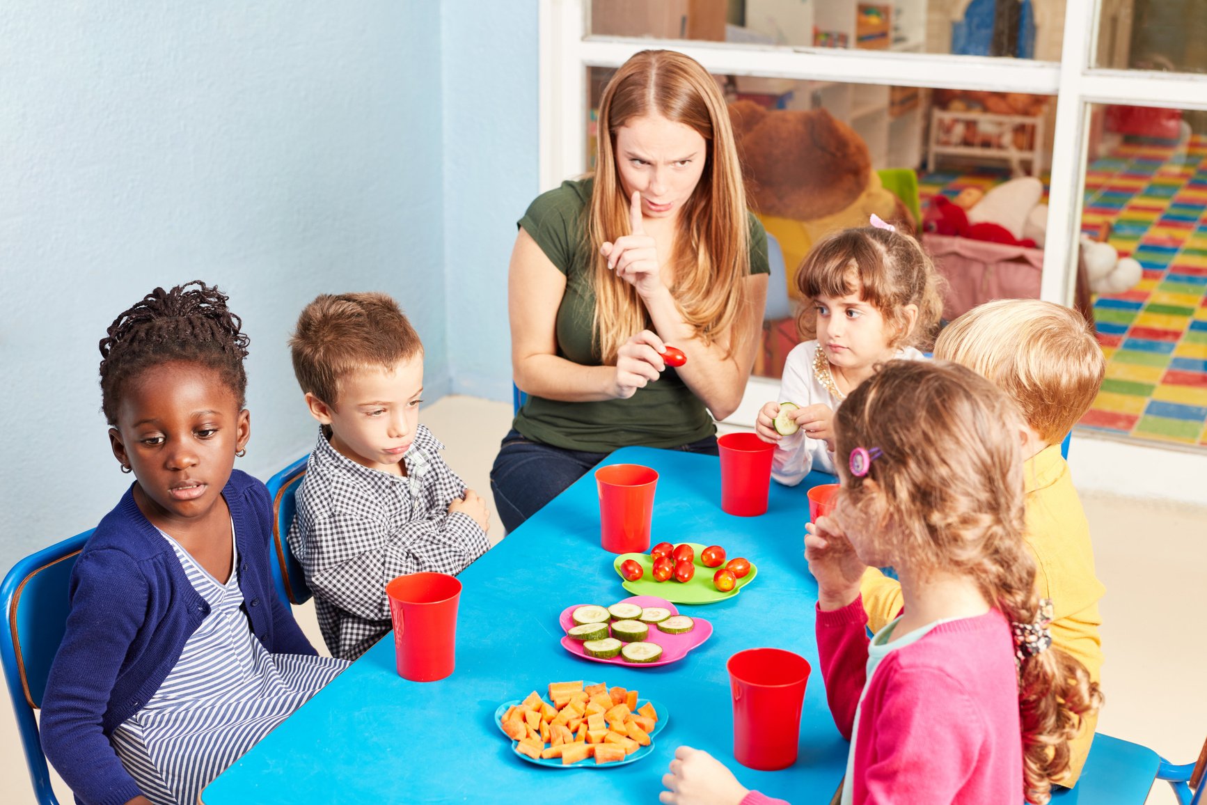 Teacher Together with Children While Eating