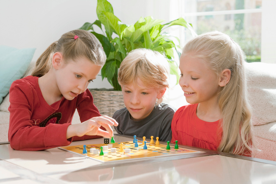 Three children playing a board game