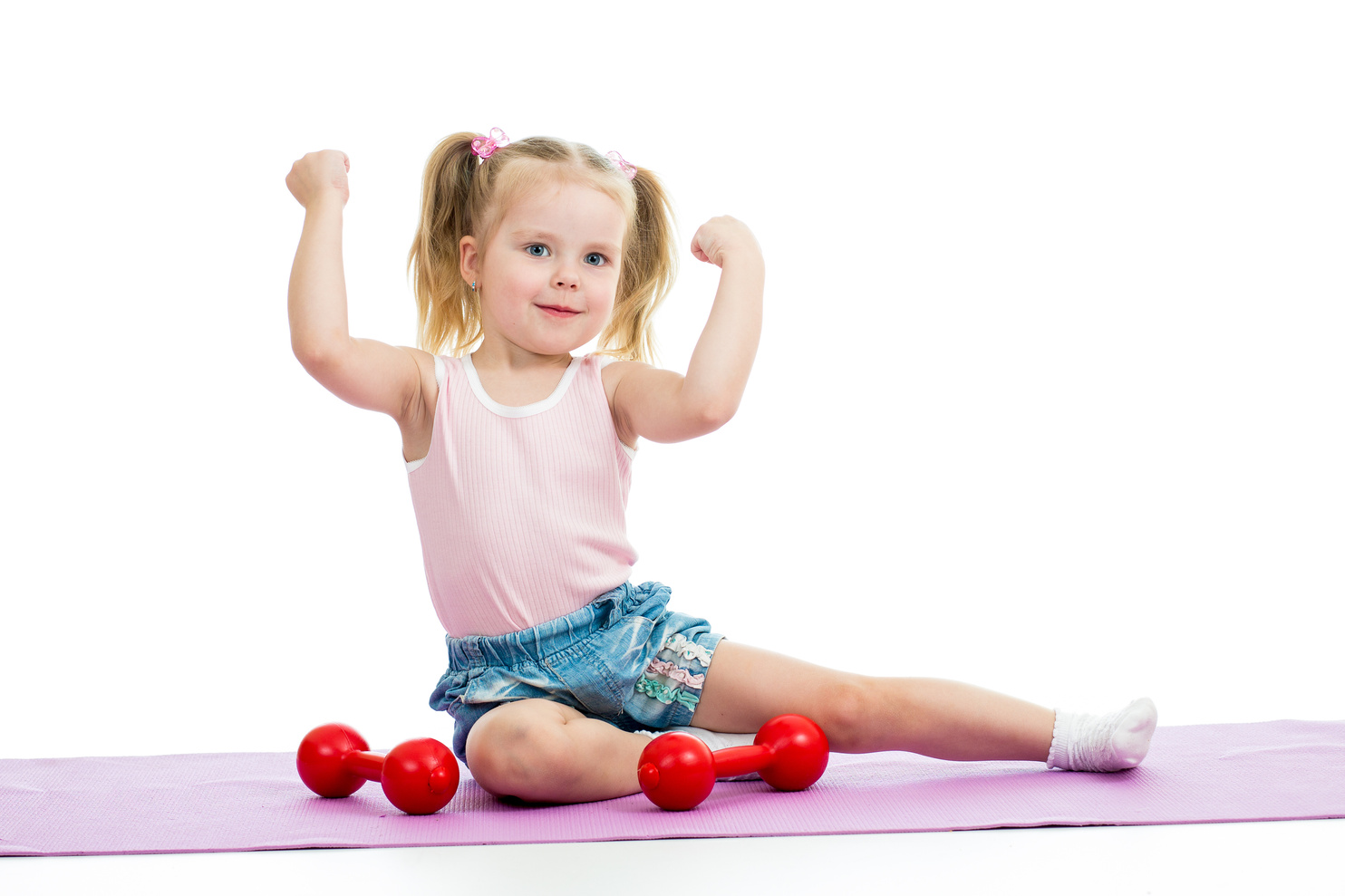 Child girl doing exercises with weights